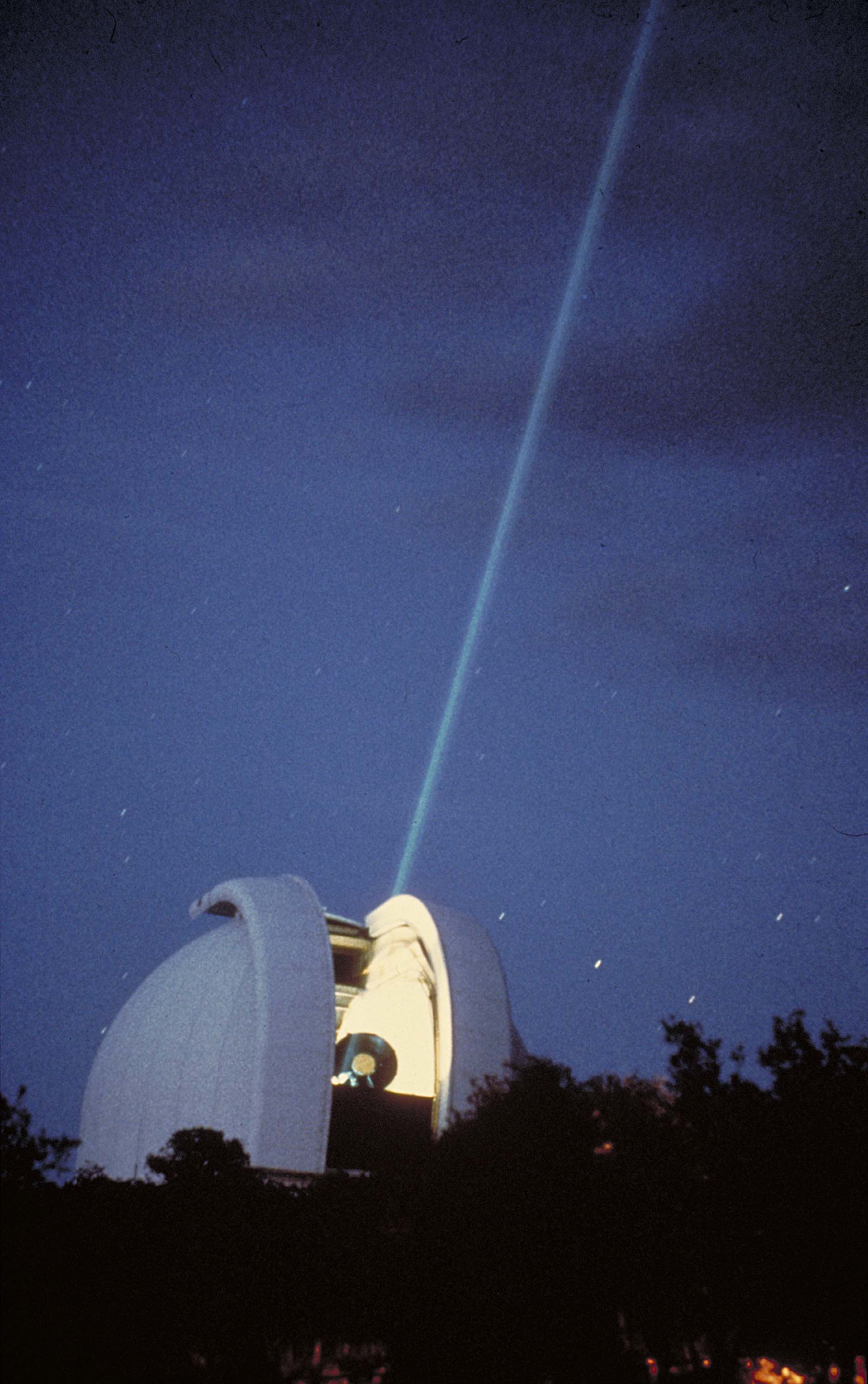 McDonald Observatory astronomers measured the Earth-Moon distance by beaming a laser from the 2.7-meter Harlan J. Smith Telescope to reflectors placed on the Moon by Apollo astronauts. Credit: Frank Armstrong/UT-Austin.